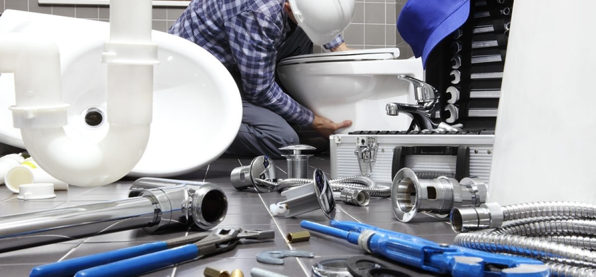 plumber at work in a bathroom, plumbing repair service, assemble and install concept